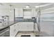 Modern kitchen features stainless steel appliances, granite counters, white cabinets and stylish backsplash at 13727 Gene Rossi Ave, Hudson, FL 34667
