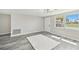 Open-concept living room with wood-look flooring, neutral walls, and natural light at 13727 Gene Rossi Ave, Hudson, FL 34667