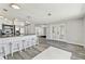 Open living space with an island bar, modern stainless steel appliances, and access to the lanai at 13727 Gene Rossi Ave, Hudson, FL 34667