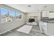 Bright living area featuring a brick fireplace, modern lighting, and breakfast bar at 13727 Gene Rossi Ave, Hudson, FL 34667