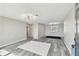 Bright living room with wood-look flooring, modern lighting, and neutral walls at 13727 Gene Rossi Ave, Hudson, FL 34667