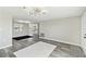Bright living room with modern lighting, gray plank floors and a neutral color palette at 13727 Gene Rossi Ave, Hudson, FL 34667