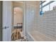 Bathroom featuring white subway tiles in the shower, decorative flooring and tub at 1410 E Curtis St # 2, Tampa, FL 33603
