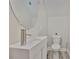 Modern half bath with a vessel sink, round mirror, and sleek fixtures on the first floor at 1410 E Curtis St # 2, Tampa, FL 33603