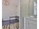 Bathroom featuring a marble vanity, decorative flooring, and an adjacent room at 1410 E Curtis St # 2, Tampa, FL 33603