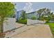 Exterior view of the home featuring a white fence and concrete driveway at 1410 E Curtis St # 2, Tampa, FL 33603