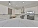Bright kitchen features white cabinets, stainless steel appliances, and a large center island with a marble countertop at 1410 E Curtis St # 2, Tampa, FL 33603