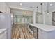 Bright, open kitchen featuring a wine cooler, microwave, stainless steel appliances, and an island with seating at 1410 E Curtis St # 2, Tampa, FL 33603
