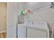 Functional laundry room featuring modern appliances, overhead shelving for storage, and a clean, efficient layout at 1410 E Curtis St # 2, Tampa, FL 33603