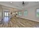 Spacious living room with hardwood floors, large windows, and an open layout to the kitchen at 1410 E Curtis St # 2, Tampa, FL 33603