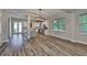Spacious living room with hardwood floors, large windows, and an open layout to the kitchen at 1410 E Curtis St # 2, Tampa, FL 33603