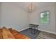 Bright home office with a decorative chandelier, dark desk, and brown leather sofa, perfect for a work-from-home professional at 1410 E Curtis St # 2, Tampa, FL 33603