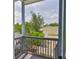 Charming porch view with mature trees, a glimpse of the sky, and a serene setting, perfect for relaxing outdoors at 1410 E Curtis St # 2, Tampa, FL 33603