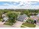 Lovely aerial view of a home with a paver driveway, well-manicured lawn, and lush landscaping at 16226 Carnoustie Dr, Odessa, FL 33556