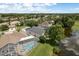 Aerial view features a screened-in pool and views of the serene neighborhood pond at 16226 Carnoustie Dr, Odessa, FL 33556