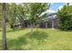 Wonderful backyard offers a screened pool, patio, green lawn, and views of natural beauty at 16226 Carnoustie Dr, Odessa, FL 33556