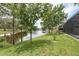 Beautiful backyard with lush lawn and trees overlooking the pond at 16226 Carnoustie Dr, Odessa, FL 33556