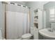 Bathroom with white shower curtain, vanity, and linen storage at 16226 Carnoustie Dr, Odessa, FL 33556