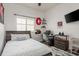 Bedroom with large window, desk, and tv, providing great space to relax at 16226 Carnoustie Dr, Odessa, FL 33556