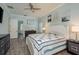Calm bedroom showcasing wood-look tile flooring and soft blue walls, creating a soothing atmosphere at 16226 Carnoustie Dr, Odessa, FL 33556