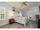 Serene bedroom featuring wood-look tile flooring, soft blue walls, and outdoor access to the backyard at 16226 Carnoustie Dr, Odessa, FL 33556