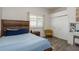 Quaint bedroom with wood-look tile floors, a large window, and ample closet space at 16226 Carnoustie Dr, Odessa, FL 33556