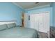 Another view of the comfortable bedroom with light blue walls and white trim at 16226 Carnoustie Dr, Odessa, FL 33556