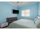 Cozy bedroom with a light blue painted walls, white trim, and great natural light at 16226 Carnoustie Dr, Odessa, FL 33556