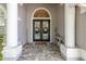 The front entrance features white columns, a double door, and decorative details at 16226 Carnoustie Dr, Odessa, FL 33556