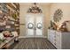 The front entrance features a rustic chandelier, a double door, and stylish furniture at 16226 Carnoustie Dr, Odessa, FL 33556