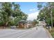 Secure gated entrance to the community with a guardhouse, well-kept landscaping, and access control at 16226 Carnoustie Dr, Odessa, FL 33556