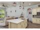 Bright kitchen showcasing a large island with white countertops, stylish lighting, and open to the living area at 16226 Carnoustie Dr, Odessa, FL 33556