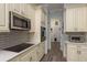 Elegant kitchen boasting stainless steel appliances, plentiful counter space, and light wood-look tile at 16226 Carnoustie Dr, Odessa, FL 33556