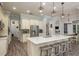Open kitchen design featuring a large island with seating, stainless steel appliances, and tile flooring at 16226 Carnoustie Dr, Odessa, FL 33556