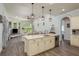 Open floor plan showcases a spacious kitchen with island and stainless steel appliances at 16226 Carnoustie Dr, Odessa, FL 33556