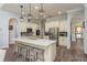 Kitchen island featuring wooden barstools, quartz countertops, and stainless steel appliances at 16226 Carnoustie Dr, Odessa, FL 33556