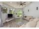 Bright living room features a large fan and windows providing great backyard views at 16226 Carnoustie Dr, Odessa, FL 33556