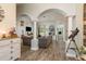 A spacious living room with neutral tones, wood-look tile floors, and decorative columns at 16226 Carnoustie Dr, Odessa, FL 33556
