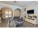 Open living room with cozy sectional couch, media center, and decorative accents at 16226 Carnoustie Dr, Odessa, FL 33556
