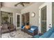 Covered patio with comfortable seating and an outdoor ceiling fan at 16226 Carnoustie Dr, Odessa, FL 33556