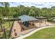Well-maintained community playground featuring a shaded play structure, swings, and surrounding green space at 16226 Carnoustie Dr, Odessa, FL 33556