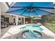 Poolside view of the hot tub, pool, patio furniture and grill in the screened-in lanai at 16226 Carnoustie Dr, Odessa, FL 33556
