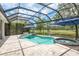 Screened-in pool and spa overlooking a beautiful backyard with pond views at 16226 Carnoustie Dr, Odessa, FL 33556