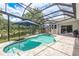 Backyard pool with lake views under a screened-in enclosure at 16226 Carnoustie Dr, Odessa, FL 33556