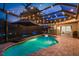 Covered pool and spa in the evening at 16226 Carnoustie Dr, Odessa, FL 33556
