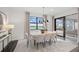 A dining room featuring a modern table and chairs, with a large window overlooking the water at 16423 Sapphire Point Dr, Lakewood Ranch, FL 34211