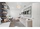 Contemporary home office/study featuring a neutral sectional, modern desk and shelving, and stylish decor at 16423 Sapphire Point Dr, Lakewood Ranch, FL 34211