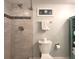 Bathroom area showing the shower stall with tiled walls, a toilet, and a towel hanger at 18650 Gulf Blvd # 314, Indian Shores, FL 33785