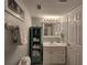 Bathroom including a vanity, mirror, and shower, and an accent shelf with towels at 18650 Gulf Blvd # 314, Indian Shores, FL 33785
