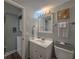 Bathroom with a sink, toilet, and a view into an adjacent laundry area, providing convenience and functionality at 18650 Gulf Blvd # 314, Indian Shores, FL 33785